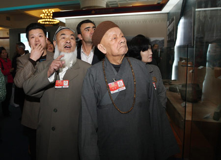 Some members of the 11th National Committee of the Chinese People's Political Consultative Conference (CPPCC), who are attending the Second Session of the 11th National Committee of the CPPCC, visit an exhibition titled 'Democratic Reform in the Tibet Autonomous Region' at the Cultural Palace of Nationalities in Beijing, capital of China, on March 11, 2009.