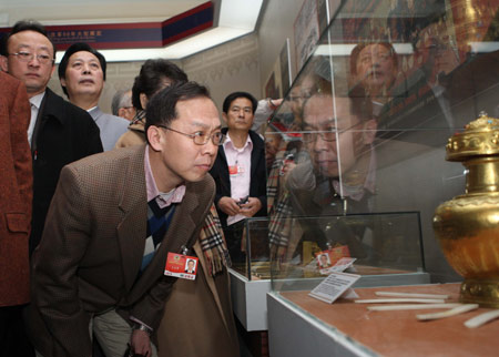 Some members of the 11th National Committee of the Chinese People's Political Consultative Conference (CPPCC), who are attending the Second Session of the 11th National Committee of the CPPCC, visit an exhibition titled Democratic Reform in the Tibet Autonomous Region at the Cultural Palace of Nationalities in Beijing, capital of China, March 11, 2009.