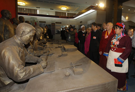 Some members of the 11th National Committee of the Chinese People's Political Consultative Conference (CPPCC), who are attending the Second Session of the 11th National Committee of the CPPCC, visit an exhibition titled Democratic Reform in the Tibet Autonomous Region at the Cultural Palace of Nationalities in Beijing, capital of China, on March 11, 2009.