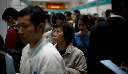  Job hunters check job information during a job fair in Hong Kong, south China, on March 11, 2009. The job fair was held by the Labour Department of the Hong Kong SAR Government, offering more than 7,000 vacancies in 80 firms.