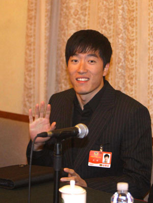 Chinese hurdler Liu Xiang, who is a member of the 11th National Committee of the Chinese People's Political Consultative Conference (CPPCC), attends a panel discussion in Beijing, on March 11, 2009. 