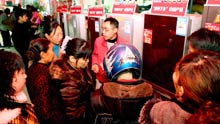 Rural residents in hustle and bustle pick out arrays of refrigerators on sales with governmental subsidies at the trade fair tour for sales promotion of home appliances to countryside, at Yanghe Township, Huaying City, southwest China's Sichuan Province, on March 11, 2009.