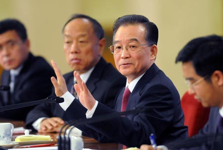 Chinese Premier Wen Jiabao (2nd R) gestures during a press conference after the closing meeting of the Second Session of the 11th National People's Congress (NPC) at the Great Hall of the People in Beijing, capital of China, on March 13, 2009. The annual NPC session closed on Friday. 