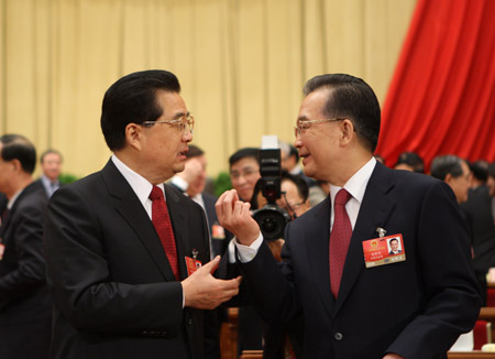 Chinese President Hu Jintao (front L) talks with Chinese Premier Wen Jiabao during the closing meeting of the Second Session of the 11th National People's Congress (NPC) at the Great Hall of the People in Beijing, capital of China, on March 13, 2009.