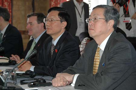 Chinese Finance Minister Xie Xuren (2nd R) and Zhou Xiaochuan (R), governor of the People's Bank of China, China's central bank, attend the opening ceremony of the G20 Finance Ministers' meeting at a hotel near Horsham in southern England on March 14, 2009.