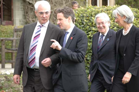 British Finance Minister Alistair Darling, US Treasury Secretary Timothy Geithner, Governor of the Bank of England Mervyn King and France's Finance Minister Christine Lagarde (L-R) arrive for a group photo at a hotel near Horsham, southern England, on March 14, 2009. The G20 Finance Ministers' Meeting kicked off on Saturday.