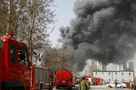 Heavy smoke and fire engines are seen on campus of China Central Academy of Fine Arts in Beijing, China, on March 16, 2009. A fire occurred in China Central Academy of Fine Arts on Monday. No casualty has been reported by now.