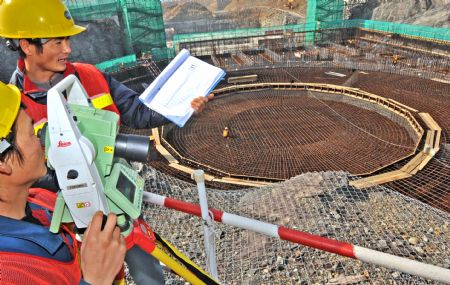 Technicians make measurements at a construction site of the Sanmen Nuclear Power Project (NPP) in east China's Zhejiang Province, on March 15, 2009. The first phase of the Sanmen NPP is now ready for startup. 