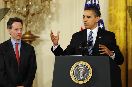 US President Barack Obama (R), accompanied by Treasury Secretary Timothy Geithner, delivers remarks to small business owners, community lenders and members of Congress at the White House in Washington on March 16, 2009. The Obama administration on Monday unveiled a plan to help unlock credit for the nation's small businesses, which generate about 70 percent of net new jobs annually. 