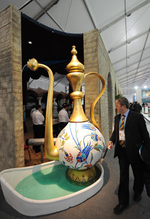 A visitor looks at a huge water jug during a water exhibition of the Fifth World Water Forum in Istanbul of Turkey, on March 18, 2009.