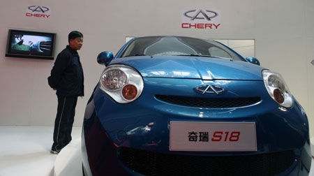 A visitor views an electric auto designed by the Chery Automobile Co. Ltd. during the China International Energy Saving, Emission Reduction and New Energy Science and Technology Expo at the Beijing Exhibition Center in Beijing, capital of China, on March 22, 2009. 