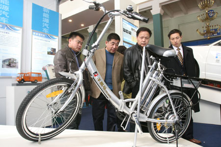 Visitors view a bicycle with power supply from hydrogen fuel cells during the China International Energy Saving, Emission Reduction and New Energy Science and Technology Expo at the Beijing Exhibition Center in Beijing, capital of China, on March 22, 2009.