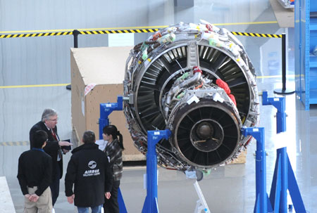 Engineers work beisde the engine of an Airbus 320 aircraft at a plant in north China's Tianjin Municipality, on March 23, 2009. Seven A320s are being assembled here. The first plane is scheduled for delivery in June.