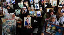 Palestinian women hold the portraits of their jailed relatives during a protest to demand the release of Palestinian prisoners held in Israeli jails, in Gaza City, on March 23, 2009. Israeli officials met with Hamas prisoners over the past few days to discuss a prisoner exchange deal that would secure the release of an Israeli soldier held captive in the Gaza Strip for over 1,000 days, a Palestinian news agency reported Monday.