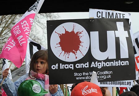 A little girl attends a demonstration in London on March 28, 2009. The Put People First group, an alliance of more than 150 unions, on Saturday organized the demonstration, calling on the leaders of the Group of 20 Countries (G20) to adopt sustainable policies that can lead the world out of recession. The demonstrators also urged the leaders to attach importance to global environment protection and to stablize the world political situation. 