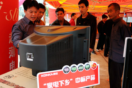 Farmers select television on a household electrical appliances market in Shatian Town of Hezhou City, southwest China's Guangxi Zhuang Autonomous Region, on March 27, 2009. 