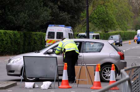 A policeman checks a car on a closed road beside the Winfield House, the official residence of the United States ambassador to Britain where US President Barack Obama will stay during the summit of the Group of 20 Countries (G20), in London on March 31, 2009.