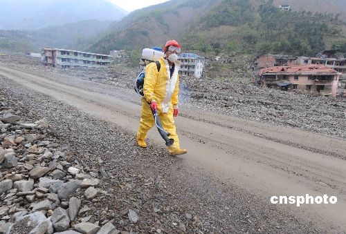 A health worker carries out disinfection on the road of Beichuan County seat southwest China's Sichuan Province on Tuesday, on March 31, 2009.