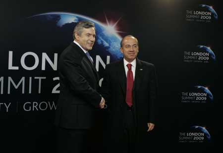 Mexican President Felipe Calderon Hinojosa (R) arrives at ExCel center and is greeted by British Prime Minister Gordon Brown for the summit of the Group of 20 Countries (G20) in London on April 2, 2009. 