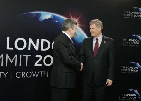  Prime Minister of Canada Stephen Harper (R) arrives at ExCel center and is greeted by British Prime Minister Gordon Brown for the summit of the Group of 20 Countries (G20) in London on April 2, 2009.