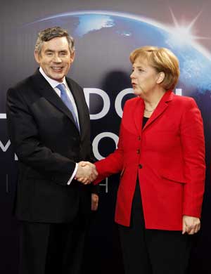 German Chancellor Angela Merkel (R) arrives at ExCel center and is greeted by British Prime Minister Gordon Brown for the summit of the Group of 20 Countries (G20) in London on April 2, 2009. 