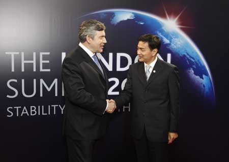 Thai Prime Minister Abhisit Vejjajiva (R) arrives at ExCel center and is greeted by British Prime Minister Gordon Brown for the summit of the Group of 20 Countries (G20) in London on April 2, 2009. 