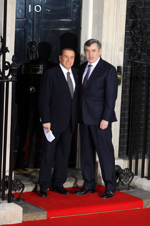 British Prime Minister Gordon Brown (R) shakes hands with Italian Premier Silvio Berlusconi at No.10 Downing Street in London April 1, 2009. Brown hosted a working dinner for the leaders attending the Group of 20 Countries (G20) summit at No. 10 Downing Street on April 1, 2009. The G20 Summit on Financial Markets and World Economy will be held in London on April 2.