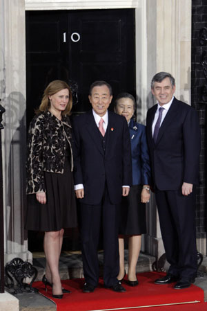 UN Secretary General Ban Ki-moon (2L) and his wife are greeted by British Prime Minister Gordon Brown (R) and his wife Sarah as they arrive at No. 10 Downing Street in London on April 1, 2009. Brown hosted a working dinner for the leaders attending the Group of 20 Countries (G20) summit at No.10 Downing Street April 1, 2009. The G20 Summit on Financial Markets and World Economy will be held in London on April 2. 