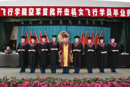 Pilot trainees pose for photos at the graduation ceremony at the Third Army Aviation Institute in China, April 2, 2009. China's first batch of female jet fighter pilots were conferred the rank of lieutenant on April 2. The 16 pilots, aged 21 to 24, graduated after 44 months of training. They will take part in the National Day parade to be held in October to mark the 60th anniversary of the founding of the People's Republic of China, a military source said.