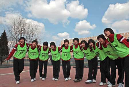 Pilot trainees encourage each other in a physique examination in China, March 30, 2009.