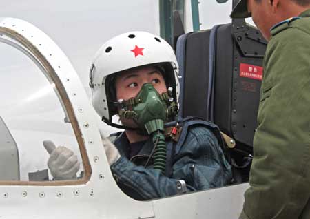 Pilot trainee Tao Jiali prepares for a flight in China, March 29, 2009. China's first batch of female jet fighter pilots were conferred the rank of lieutenant on April 2. The 16 pilots, aged 21 to 24, graduated after 44 months of training. They will take part in the National Day parade to be held in October to mark the 60th anniversary of the founding of the People's Republic of China, a military source said. 