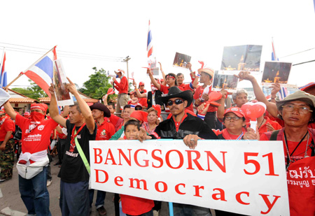 Demonstrators attend a protest outside the place where foreign delegations for the ASEAN related summits stayed in Pattaya, Thailand, on April 11, 2009. A scheduled 12th ASEAN-China Summit was postponed on Saturday as anti-government 'red shirt' blocked all main roads in Pattaya, Thailand's acting government spokesman Panitan Wattanayakorn said. 