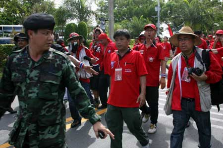 Anti-government demonstrators arrive at the front gate of the Royal Cliff Beach Resort Hotel, the venue of the 14th ASEAN Summit and Related Summits, in Pattaya, Thailand, on April 11, 2009. A scheduled 12th ASEAN-China Summit was postponed on Saturday due to anti-government 'red shirt' blocked all main roads in Pattaya, Thailand's acting government spokesman Panitan Wattanayakorn said.