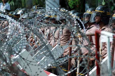 Soldiers guard beside barricades at the front gate of the Royal Cliff Beach Resort Hotel, the venue of the 14th ASEAN Summit and Related Summits, in Pattaya, Thailand, on April 11, 2009. 