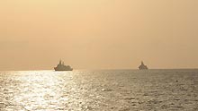 Warships of the second group of Chinese navy escort ships are seen in the sunrise in the Gulf of Aden on April 13, 2009. The flotilla converged with the first group of Chinese navy escort ships in the Gulf of Aden on Monday.