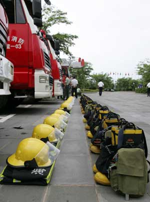 Firefighters await orders outside the main hall where Boao Forum for Asia (BFA) Annual Conference 2009 due to be held, in Boao, a scenic town in south China's Hainan Province, on April 16, 2009.