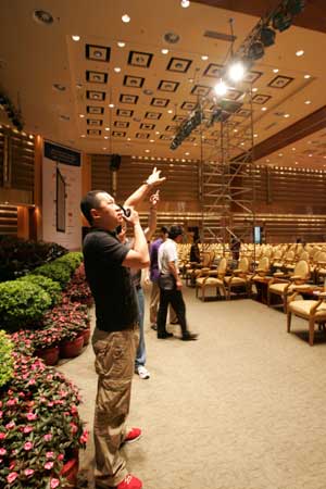 Staff members test the illumination equipments at the main hall where the Boao Forum for Asia (BFA) Annual Conference 2009 due to be held, in Boao, a scenic town in south China's Hainan Province, on April 16, 2009. 