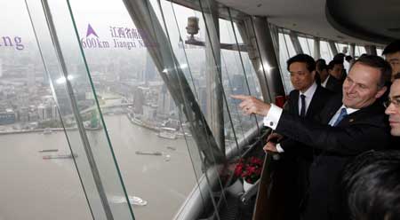 New Zealand Prime Minister John Key (R) gestures as he view the city scene in Shanghai, China, on April 16, 2009. Key is to head to south China's Hainan Province for the 2009 meeting of the Bo'ao Forum for Asia from April 17 to 19.