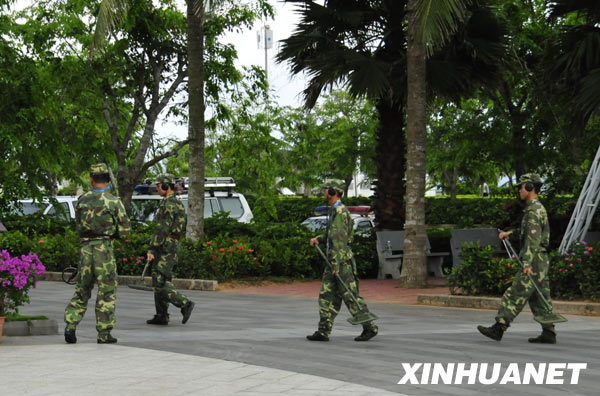 Armed police officers carry out security check near the venue for the Boao Forum for Asia (BFA) Annual Conference 2009, in Boao, a scenic town in south China's Hainan Province, on April 16, 2009. The 3-day BFA Annual Conference 2009 will kick off here Friday with the theme of 'Asia: Managing Beyond Crisis.'