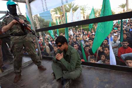 Palestinians act as prisoners to call for the release of the Palestinian prisoners held in Israeli jails during a demonstration in Gaza City, on April 16, 2009.