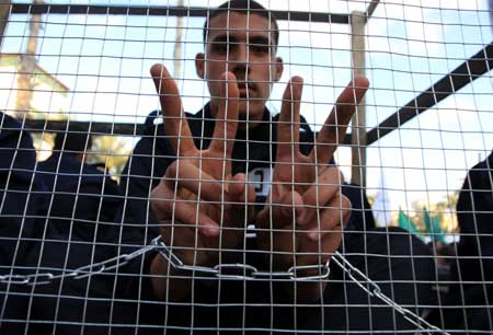 A Palestinian acts as a prisoner in a demonstration held by Hamas movement, calling for the release of Palestinian prisoners in Israeli jails in Gaza City, on April 16, 2009.