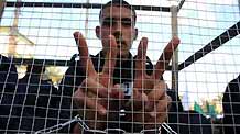 A Palestinian acts as a prisoner in a demonstration held by Hamas movement, calling for the release of Palestinian prisoners in Israeli jails in Gaza City, on April 16, 2009.