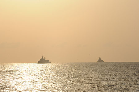 Warships of the second group of Chinese navy escort ships are seen in the sunrise in the Gulf of Aden on April 13, 2009. The flotilla converged with the first group of Chinese navy escort ships in the Gulf of Aden on Monday. 