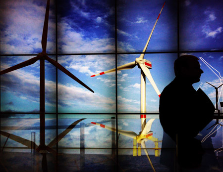 A visitor passes by the exhibition stand of wind power during the 'Hannover Messe' industrial trade fair in Hanover, Germany, on April 20, 2009. Clean energies as solar power and wind power are welcomed during the fair.
