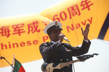 A member of Bangladeshi navy's military band sings during a performance in Qingdao, east China's Shandong Province, on April 21, 2009.