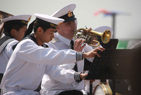 A member of Russian navy's military band (1st R) attends a performance in Qingdao, east China's Shandong Province, on April 21, 2009.