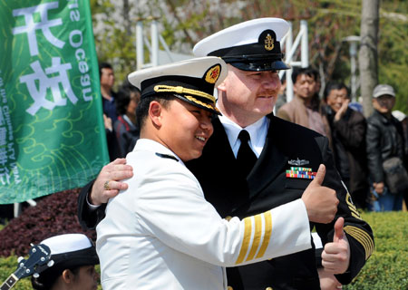 Officers from US Navy and Chinese People's Liberation Army Navy pose for a photo after a performance in Qingdao, east China's Shandong Province, on April 21, 2009.