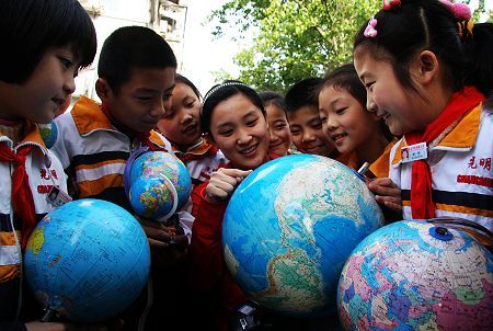 A teacher imparts knowledge about the Earth to students in the Guanminglu Primary School in Zaozhuang City of Shandong Province on April 21, 2009. The Earth Day, celebrated on every April 22, is a day designed to inspire people's awareness and appreciation for the Earth's environment.