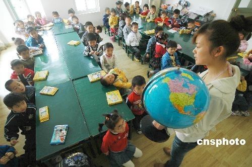 A teacher imparts knowledge about the Earth to children in the New Century Kindergarten of Chaohu City in Anhui Province on April 21, 2009. The Earth Day, celebrated on every April 22, is a day designed to inspire people's awareness and appreciation for the Earth's environment. 