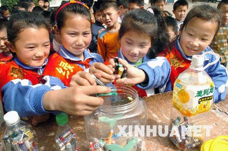 Students collect old used batteries in the Shenzhou School, Xiangfan City of Hubei Province, on April 20, 2009. The Earth Day, celebrated on every April 22, is a day designed to inspire people's awareness and appreciation for the Earth's environment. 